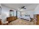 Spacious bedroom with a queen bed, dresser, and a comfortable sitting chair at 663 S Xenon Ct, Lakewood, CO 80228