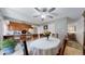 Dining room with six-chair dining set, view into the kitchen, and ceiling fan at 663 S Xenon Ct, Lakewood, CO 80228