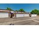 Street view of multi-Gathering townhomes with attached garages and fenced entrances at 663 S Xenon Ct, Lakewood, CO 80228