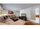 Cozy living room features a comfortable sectional, ottoman, and entertainment center at 663 S Xenon Ct, Lakewood, CO 80228