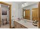 Bathroom featuring vanity, large mirror, and access to shower at 24768 Foothills N Dr, Golden, CO 80401