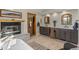 Bathroom featuring vanity, soaking tub, and fireplace at 24768 Foothills N Dr, Golden, CO 80401