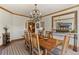Dining room with chandelier, wood trim, and a decorative mirror over a credenza at 24768 Foothills N Dr, Golden, CO 80401