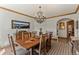Dining room with a chandelier, wood table, and views to other rooms in the home at 24768 Foothills N Dr, Golden, CO 80401