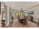 Elegant dining room featuring chandelier, buffet, and access to outdoor balcony at 24768 Foothills N Dr, Golden, CO 80401