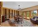 Cozy dining area featuring a custom bookcase and a beautiful view of the outdoors at 24768 Foothills N Dr, Golden, CO 80401