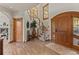 Inviting foyer featuring wood floors, staircase, arched windows and ample lighting at 24768 Foothills N Dr, Golden, CO 80401