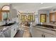 Bright kitchen featuring stone countertops, island, and dining area with scenic views at 24768 Foothills N Dr, Golden, CO 80401