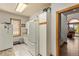 Bright kitchen with white appliances, tile floor, and natural wood trim doorway at 24768 Foothills N Dr, Golden, CO 80401