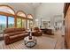 Bright living room showcasing large windows, and comfortable leather sofas at 24768 Foothills N Dr, Golden, CO 80401