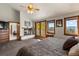 Main bedroom featuring a fireplace, balcony access, and lovely natural light at 24768 Foothills N Dr, Golden, CO 80401