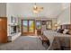Bright main bedroom featuring a fireplace, balcony access, and lovely natural light at 24768 Foothills N Dr, Golden, CO 80401