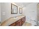 Bathroom featuring a double sink vanity, tile countertops, and classic wood cabinetry at 875 E 78Th Ave # 9-2, Denver, CO 80229