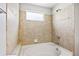 Bathroom with a soaking tub surrounded by decorative tile work, creating a relaxing retreat at 875 E 78Th Ave # 9-2, Denver, CO 80229