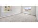 Bright bedroom featuring two windows and neutral carpeting, offering a serene and inviting space at 875 E 78Th Ave # 9-2, Denver, CO 80229