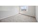 Bright bedroom featuring neutral walls, a window, a baseboard, and plush gray carpeting at 875 E 78Th Ave # 9-2, Denver, CO 80229