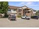 Condo exterior featuring brick accents, siding, multiple balconies, and convenient parking spaces at 875 E 78Th Ave # 9-2, Denver, CO 80229