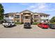 Exterior view of a well-maintained two-story building with a parking lot in front at 875 E 78Th Ave # 9-2, Denver, CO 80229