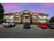 Condo exterior featuring brick accents, siding, multiple balconies, and convenient parking spaces at 875 E 78Th Ave # 9-2, Denver, CO 80229