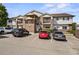 Condo exterior featuring brick accents, siding, multiple balconies, and convenient parking spaces at 875 E 78Th Ave # 9-2, Denver, CO 80229