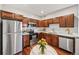 Well-equipped kitchen with stainless steel appliances and warm wood cabinets, complemented by white countertops at 875 E 78Th Ave # 9-2, Denver, CO 80229