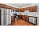 Modern kitchen with stainless steel appliances, white countertops, and wood finished cabinets at 875 E 78Th Ave # 9-2, Denver, CO 80229