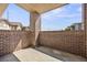 Enclosed outdoor patio with brick walls providing privacy and a cozy space for relaxation at 875 E 78Th Ave # 9-2, Denver, CO 80229