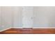 Neutral room with pristine white door, hardwood floor and white walls, with electrical outlet at 875 E 78Th Ave # 9-2, Denver, CO 80229