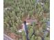Expansive aerial view showing the home's wooded lot, long driveway, and surrounding trees at 4305 Red Rock Dr, Larkspur, CO 80118