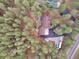 Aerial view of the home with surrounding trees and circular driveway and additional parking at 4305 Red Rock Dr, Larkspur, CO 80118