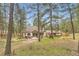 Private backyard offering mature trees, patio, hot tub, playground and a serene natural setting at 4305 Red Rock Dr, Larkspur, CO 80118