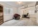 Finished basement featuring a window, gray beanbag, and a built-in desk and bookcase at 4305 Red Rock Dr, Larkspur, CO 80118
