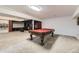 A finished basement featuring a pool table, media room and built-in shelving at 4305 Red Rock Dr, Larkspur, CO 80118