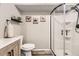 Finished bathroom with rustic decor, light wood floors, and glass-enclosed shower stall at 4305 Red Rock Dr, Larkspur, CO 80118