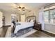 A stylish bedroom featuring a decorative rug, dark wood floors and a black metal frame bed at 4305 Red Rock Dr, Larkspur, CO 80118