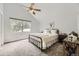 Bright bedroom featuring a sloped ceiling, neutral carpet, and a black metal frame bed at 4305 Red Rock Dr, Larkspur, CO 80118