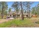 Back of home featuring wooden porch with outdoor seating, hot tub and a playset in the backyard at 4305 Red Rock Dr, Larkspur, CO 80118
