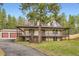 Charming two-story home with a large front porch and a detached two car garage at 4305 Red Rock Dr, Larkspur, CO 80118