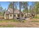 Back of home featuring wooden porch with outdoor seating, hot tub and a playset in the backyard at 4305 Red Rock Dr, Larkspur, CO 80118