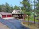 View of a two-story home with a three-car garage and a wraparound porch at 4305 Red Rock Dr, Larkspur, CO 80118