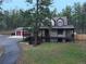 Charming two-story home with a spacious front porch and mature trees at 4305 Red Rock Dr, Larkspur, CO 80118
