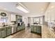 Spacious kitchen with stainless steel appliances, granite countertops, custom cabinetry and wood flooring at 4305 Red Rock Dr, Larkspur, CO 80118