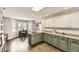 Lovely kitchen featuring two-toned cabinets, a kitchen island, stainless steel appliances, and a breakfast nook at 4305 Red Rock Dr, Larkspur, CO 80118