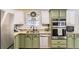 Bright kitchen features granite counters, stainless appliances and custom cabinetry at 4305 Red Rock Dr, Larkspur, CO 80118