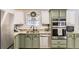 Charming kitchen featuring granite countertops, stainless steel appliances, and a white tile backsplash at 4305 Red Rock Dr, Larkspur, CO 80118