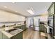Well lit kitchen featuring stainless steel appliances, granite countertops, and a kitchen island with hardwood floors at 4305 Red Rock Dr, Larkspur, CO 80118
