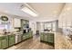 Bright kitchen features updated stainless-steel appliances, wooden floors and custom cabinetry at 4305 Red Rock Dr, Larkspur, CO 80118