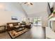 Bright living room featuring vaulted ceilings, a cozy fireplace, and access to the outdoors at 4305 Red Rock Dr, Larkspur, CO 80118