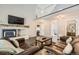 Open-concept living area with a cozy fireplace and views of the upper-level loft space at 4305 Red Rock Dr, Larkspur, CO 80118