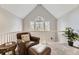 Comfortable sitting area with a leather chair, ottoman, and large window with forest views at 4305 Red Rock Dr, Larkspur, CO 80118